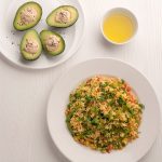 Warm millet salad and avocado stuffed with hummus